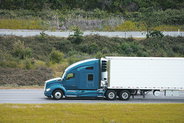 A reefer trailer travels on a highway